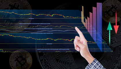 Hand staff point on trend line of Bitcoin crypto currency, blur data numeric analysis forex  growth graph stock market.symbols. business or finance. plan investment income for 2023 new year concept.