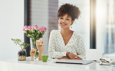 Success is her game. Shot of a beautiful young businesswoman working in her office.