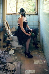 woman with gas mask on a toilet