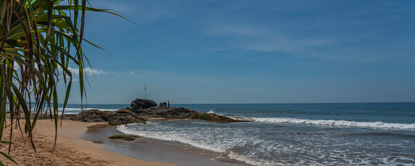 Rocks at the shore of Bentota beach, Indian Ocean at Sri Lanka