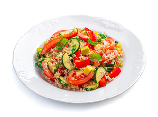 Vegetable salad with quinoa, avocado, tomatoes, cucumber, pepper and fresh herbs is isolated on a white background.