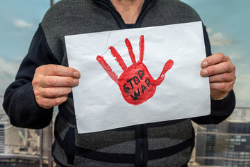 Man hold poster with text stop war in Ukraine,  protest against Russian attack on Ukraine