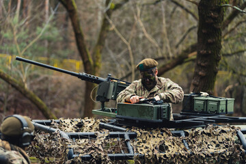 Checking bullets armoury stock in camouflaged attack truck . High quality photo