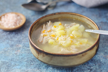 A bowl with chicken soup with pasta	