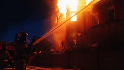 The roof of the house is on fire. The residential building burn, village. Firefighters put out a...