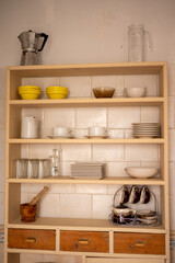 Kitchen cupboard with containers. Glasses, cups, coffee pot, jugs