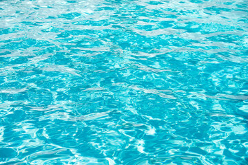 Abstract ripple wave and clear turquoise water surface in swimming pool, blue water wave for background and abstract design.