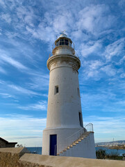 Fototapeta na wymiar White lighthouse in the idyllic landscape