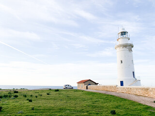 Fototapeta na wymiar White lighthouse in the idyllic landscape