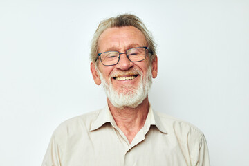 Portrait of happy senior man with a gray beard in a shirt and glasses isolated background