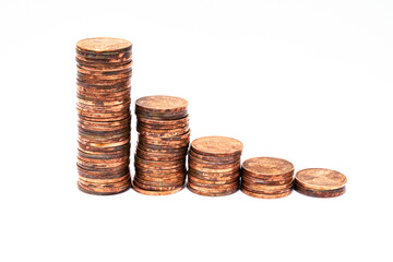 Stacks of copper coins decreasing in height. Symbolic for currency depreciation or inflation.
