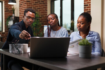 African american businessman introducing to colleagues new management and business plan while in...