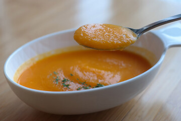 Use a spoon to scoop up the thick pumpkin soup.