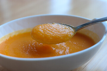 Use a spoon to scoop up the thick pumpkin soup.