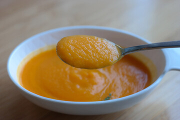 Use a spoon to scoop up the thick pumpkin soup.