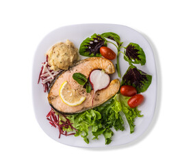 Top view smoked salmon steak with matched potatoes , mixed salad and vegetables on white background