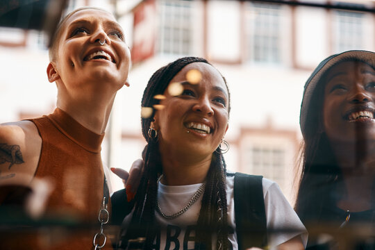 This Store Definitely Has Our Attention. Shot Of Three Close Friends Spending The Day Together In The City.