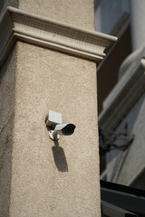 surveillance camera mounted on the facade of a hotel.