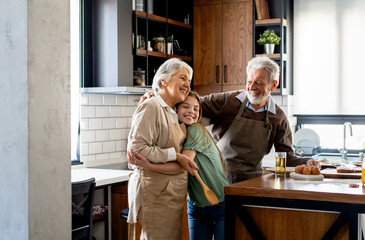 Young girl having breakfast with her grandparents. Generation family happiness concept