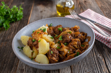 Meatball dish with fried cabbage, brown sauce and potatoes