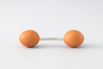 Natural eggs with gym barbbell. Easter and fitness concept. Minimal workout composition.