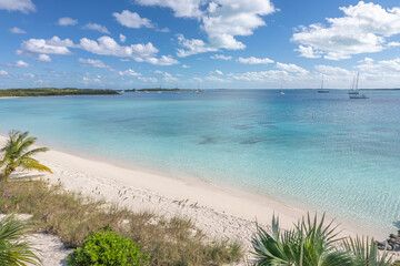 Fototapeta na wymiar Stocking Island beach with pink sand, coconut palms and turquoise water, Great Exuma, Bahamas.