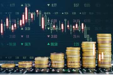 Creative image of growing coin stacks and candlestick forex chart on blurry backdrop. Trade, money and financial growth concept. Double exposure.