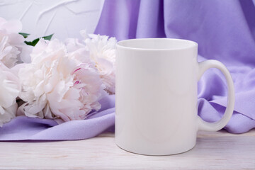 White coffee mug mockup with pink peony and lilac scarf
