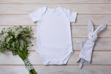 White baby short sleeve bodysuit mockup with wild flowers and bunny rabbit toy