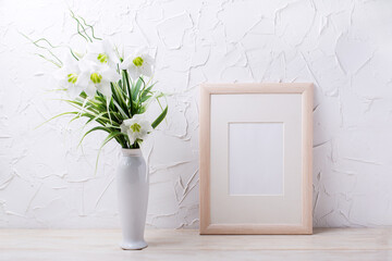 Wooden frame mockup with lily in the white vase