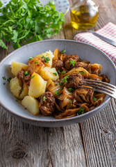 Rustic dish with meatballs, cabbage, sauce and potatoes