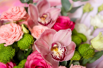 Bright pink flowers bouquet closeup. Roses and orchids wallpaper. Beautiful background for a Birthday, International Female Day, or Saint Valentine. The festive backdrop for a postcard design