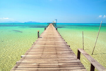 Beautiful wooden bridge in Thailand.Sitting on the terrace by the sea.