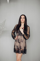 Gorgeous brunette model in black dress and heels