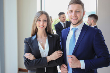 Group of business people at a meeting on the background of office. Focus on a beautiful brunet