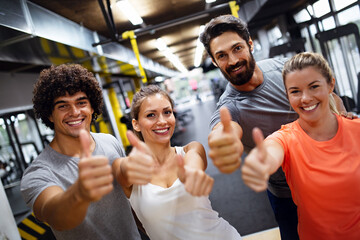 Portrait of happy fit people, friends exercising in gym together. Sport people workout concept