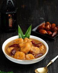 Kolak Pisang Kurma or Banana Dates Fruit Compote Made from Sliced Banana and Dates Fruit Stew in Coconut Milk and Brown Sugar.