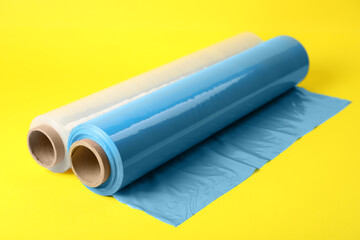 Rolls of different stretch wrap on yellow background