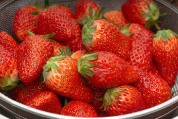 Fresh strawberries in a basket over white background