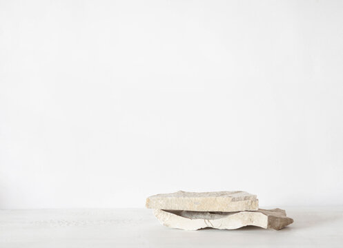 Grey natural stones podium on white background, platform for product display