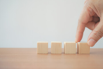 hand arranging group of wooden block on the table with white background for graphic resource element of banner design  concept