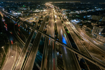 Fototapeta na wymiar car traffic transportation above intersection road is important infrastructure in Bangkok Thailand, aerial view Hyperlapse cityscape of advanced innovation and financial technology.
