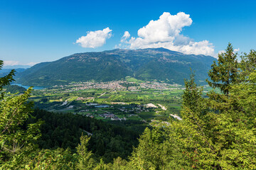 Fototapeta na wymiar Aerial view of the Sugana valley (Valsugana) with the small town of Levico Terme and lake Levico, Mountain range of Lagorai. Tourist resort in Trento province, Trentino Alto Adige, Italy, Europe.