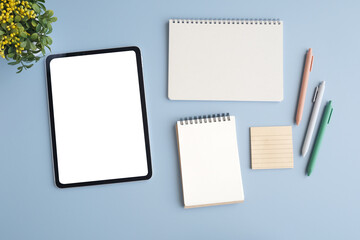Digital tablet with blank on screen, note papers and pen isolated on gray background, for template, mock up, topview, flat lay, communication technology