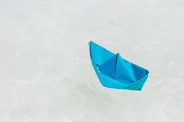 Paper Ship Floating in the Sea. Origami Paper Boat Sailing. Travel Concept.