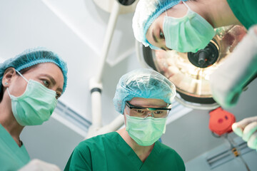 Low Angle Shot of Professional surgeons team performing surgery in operating room, surgeon,...