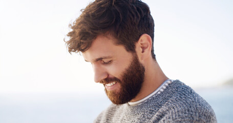 The beard is what makes the man. Cropped shot of a handsome young man spending the day at the beach.