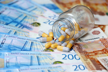 Pills on banknotes of the russian rubles. Medication in capsules, concept of pharmaceutical business, rise in price of medicines, healthcare in Russia