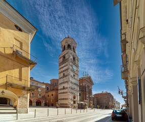 Fossano, Italy - February 27, 2022: the Civic bell tower (XV century) and Cathedral of Santa Maria...