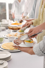 People taking food during breakfast, closeup. Buffet service